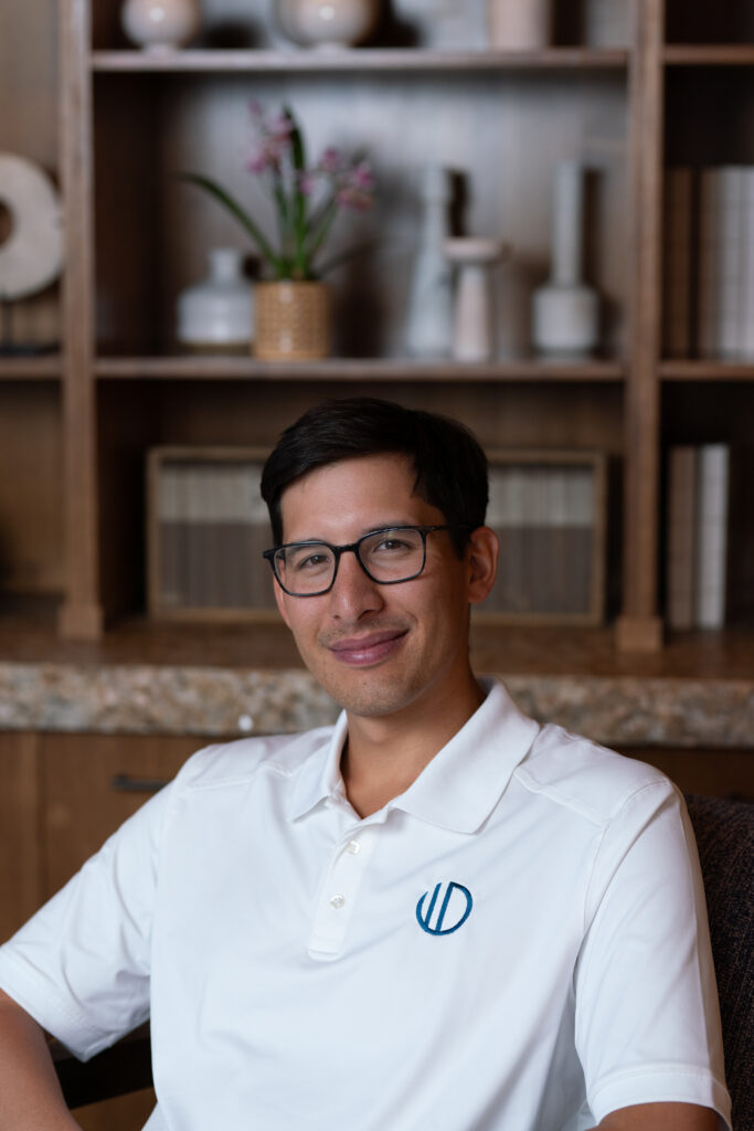Smiling person in a white polo shirt