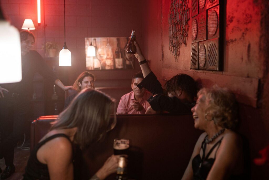 Friends gather in a dimly lit bar.
