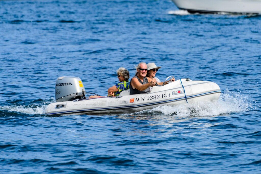 Three people enjoying a ride in a motorboat.