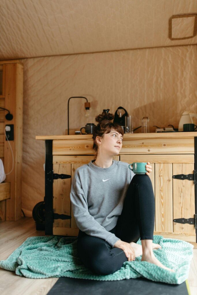 Woman sitting on floor with mug